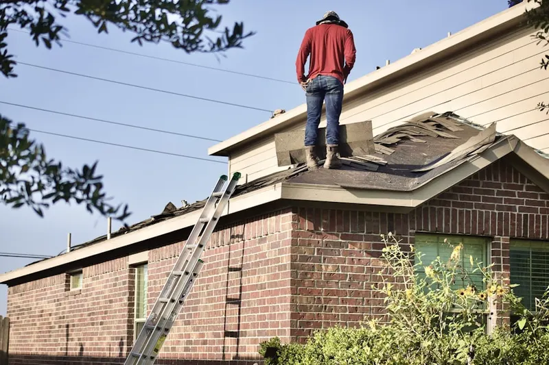 Professional roofer working on a residential roof in Bucknell Manor